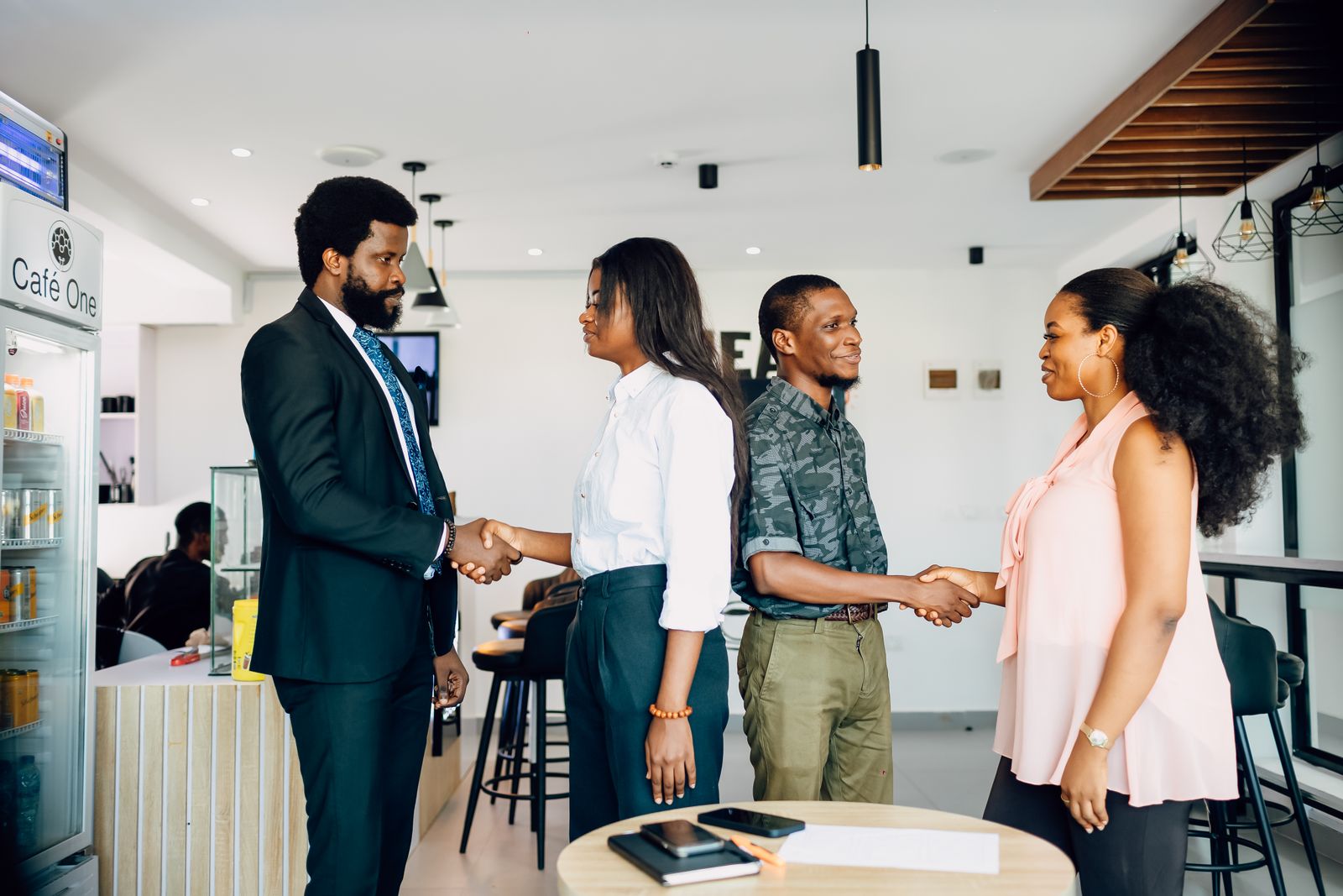 African professionals greeting each other with handshakes at the start of a training session