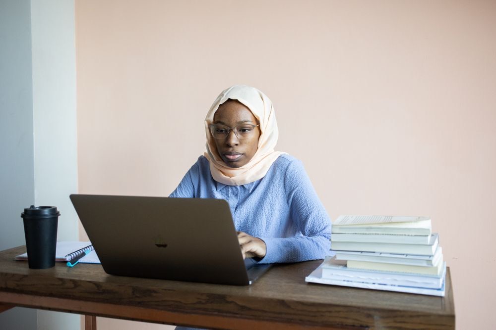 A learner studying on a laptop at her own pace